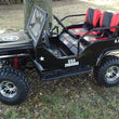 Load image into Gallery viewer, Miniature black U.S. Army jeep with red and black seats parked on grass.