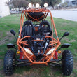 Load image into Gallery viewer, Off-road dune buggy with orange frame and black seats parked on grassy area.