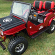 Load image into Gallery viewer, Red custom mini jeep with black accents, military star on hood, and off-road tires parked on grass.
