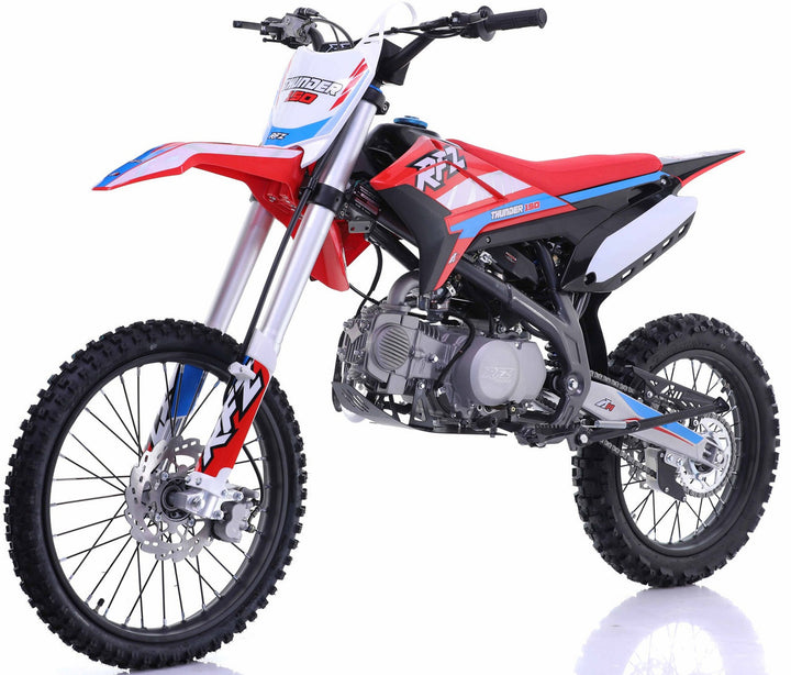 Red and white dirt bike with a sporty design, featuring knobby tires, front suspension, and a sleek seat suitable for off-road adventures.